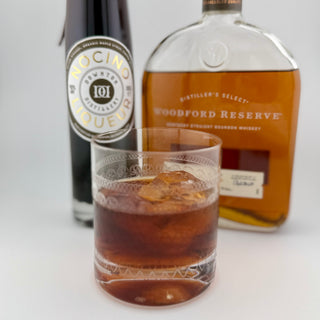Manhattan Cocktail, with a bottle of Woodford Reserve whiskey and Downton Distillery Nocino 
