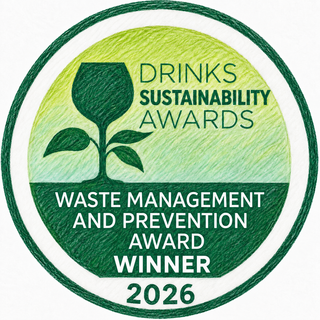 A circular award badge for the Drinks Sustainability Awards, recognizing Waste Management and Prevention as the 2026 winner. The badge features a green and yellow textured background with a wine glass and plant icon, and white text.