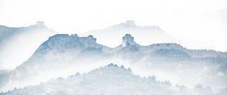 Great Wall of China amidst misty mountains. 