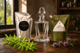 Alcohol decanter with 'Explorer's Club' coffee package and 'Great Bustard Gin' bottle on a wooden surface.