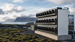 Large industrial machine or power station with a scenic landscape in the background