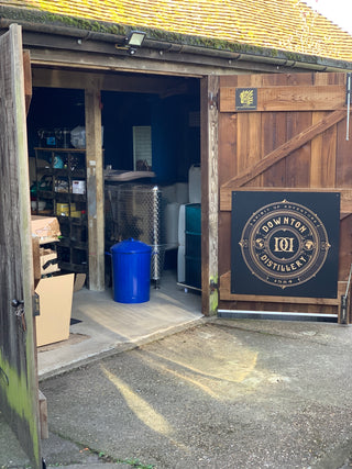 Blue barrel on a wooden platform with a logo in the background